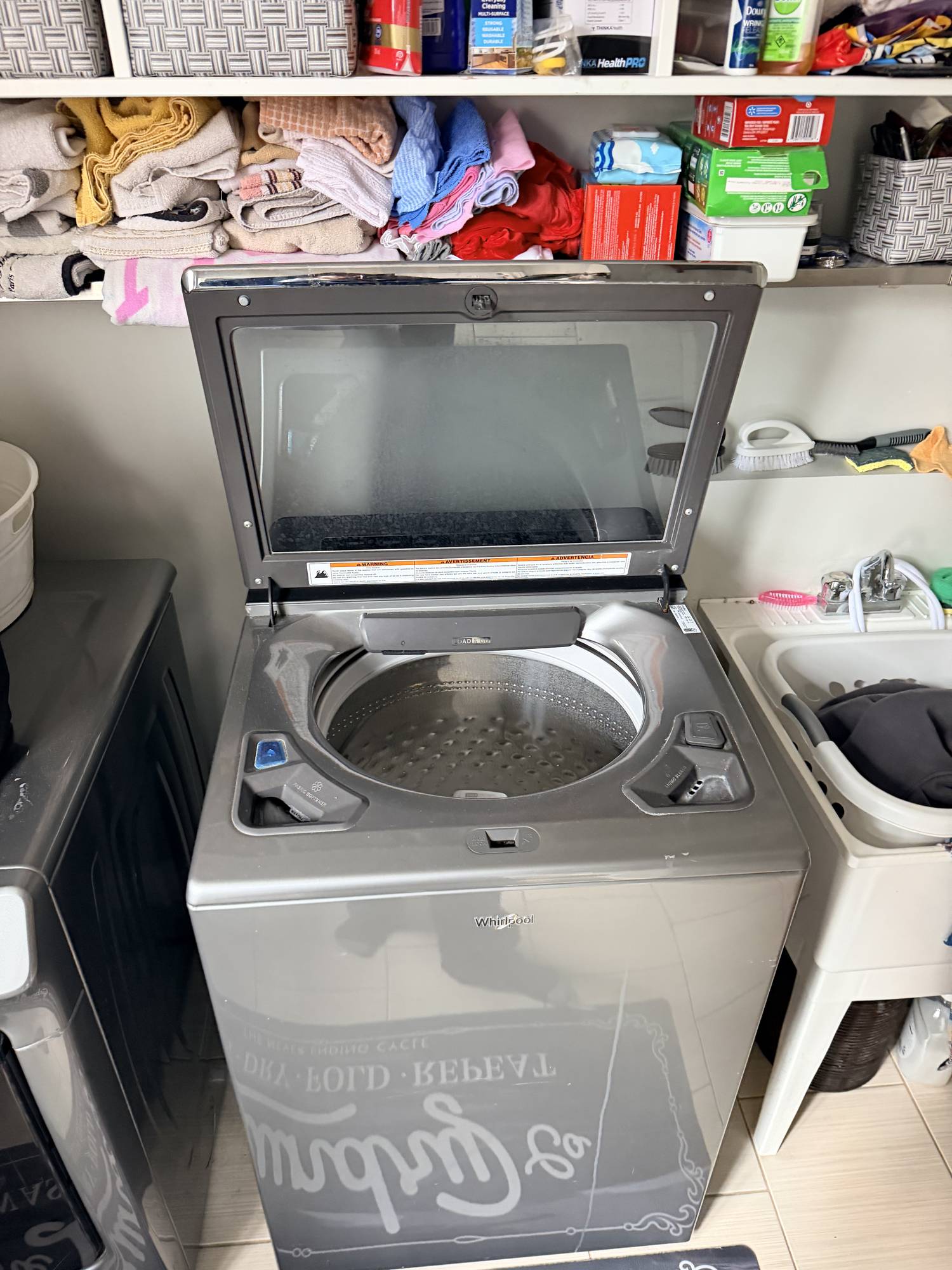 LG front-load washer drum showing an overloaded laundry imbalance that triggers the LE error code