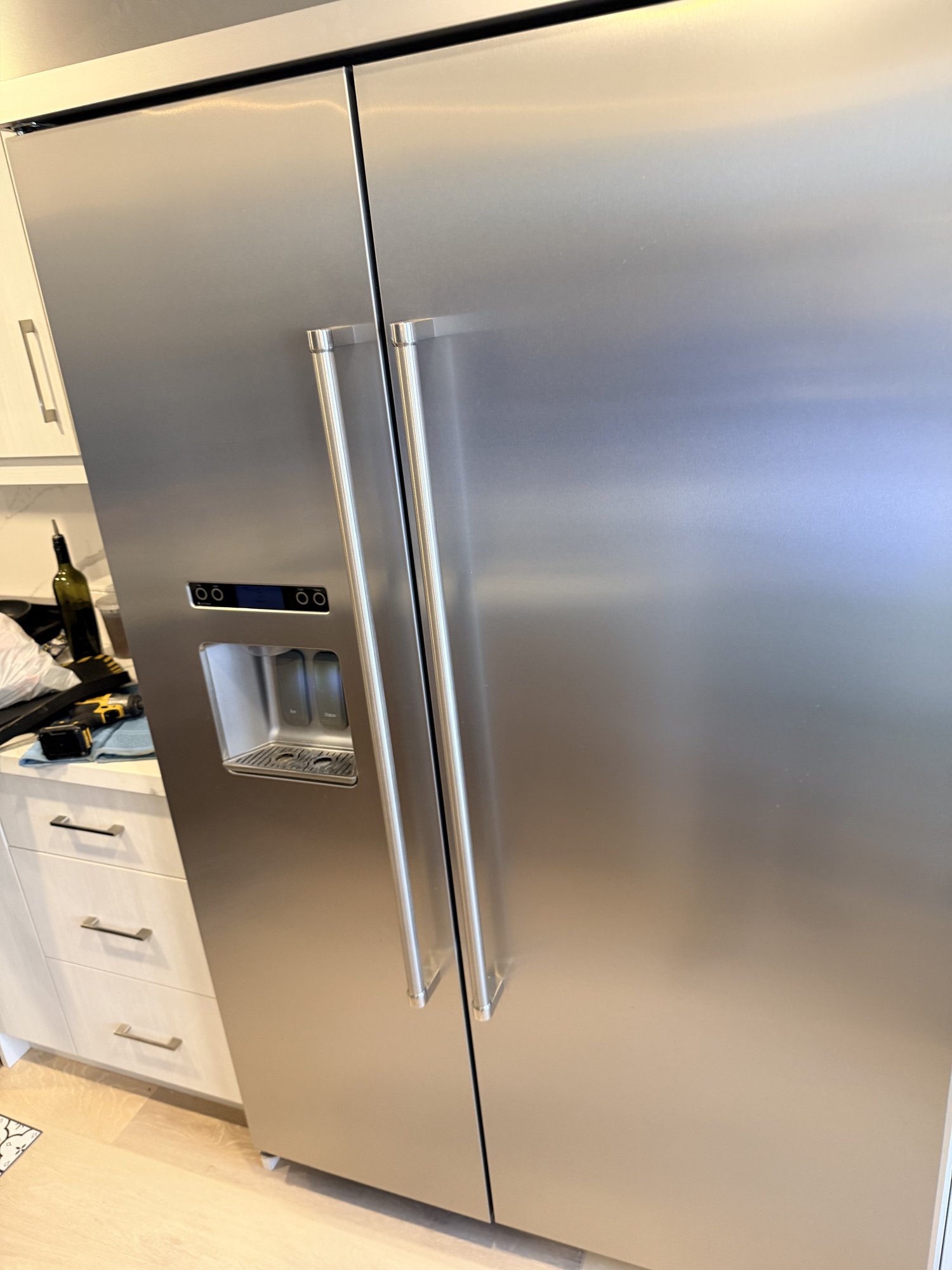 Samsung RF-series French-door refrigerator showing the control panel and dispenser display