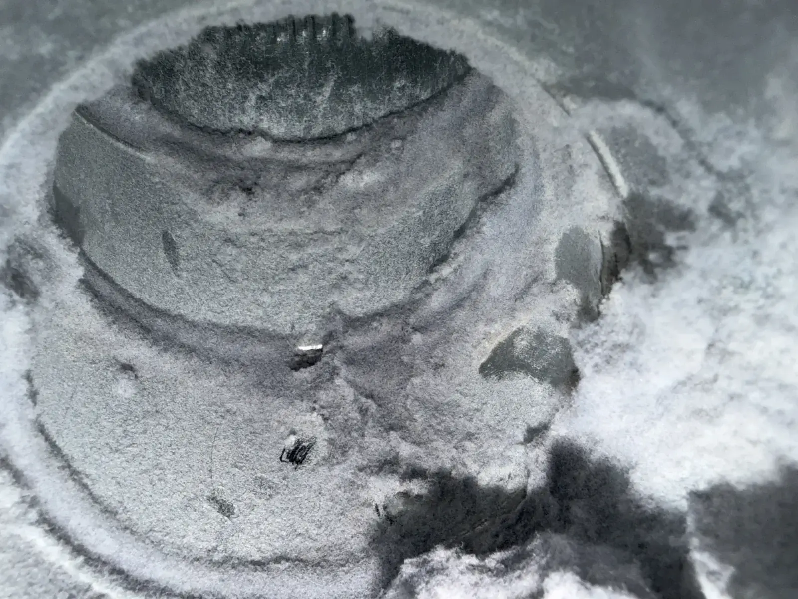 appliance repair close up metallic circular surface coated gray dust powder show