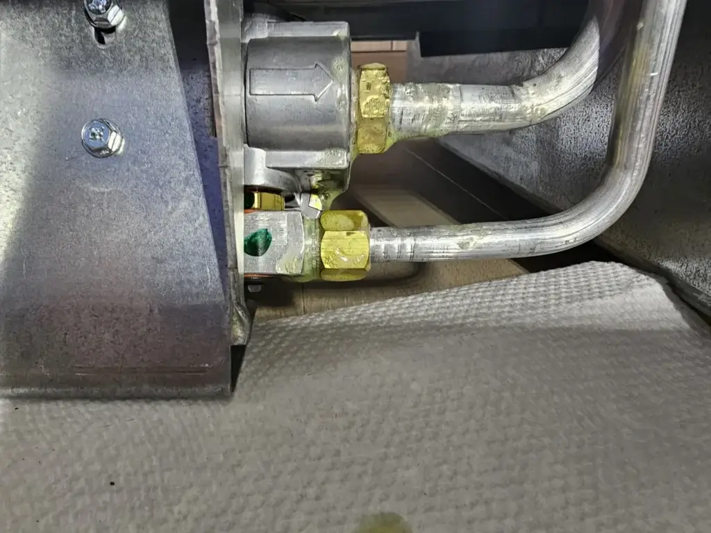appliance repair close up two metal pipes connected brass fittings green residue