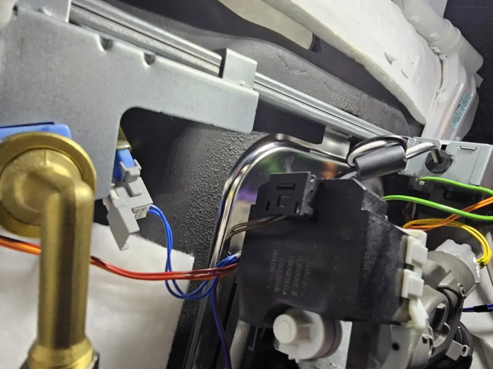 appliance repair close up view internal components machine showing various wires