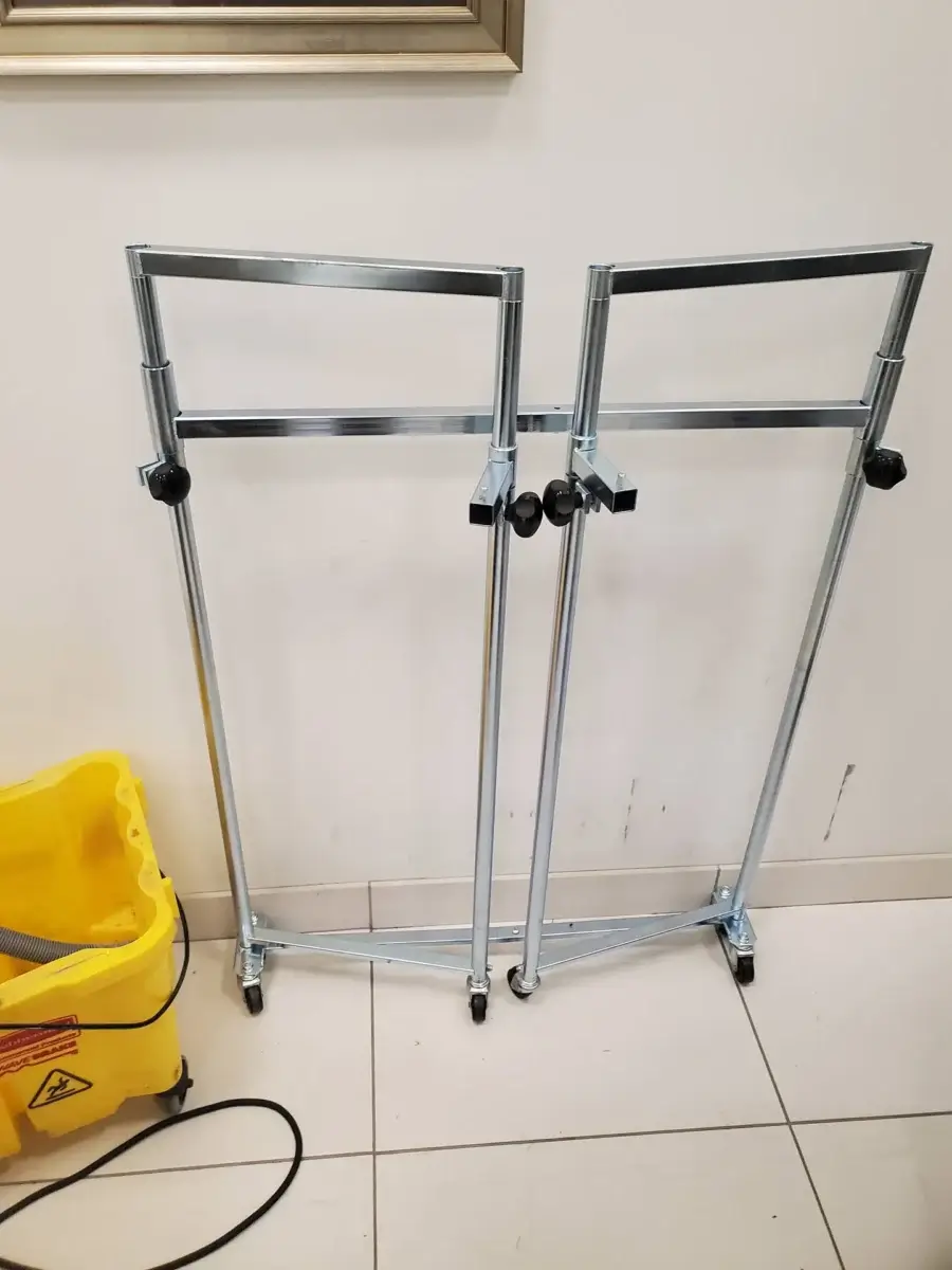 appliance repair two metal folding frames wheels lean against white wall next ye