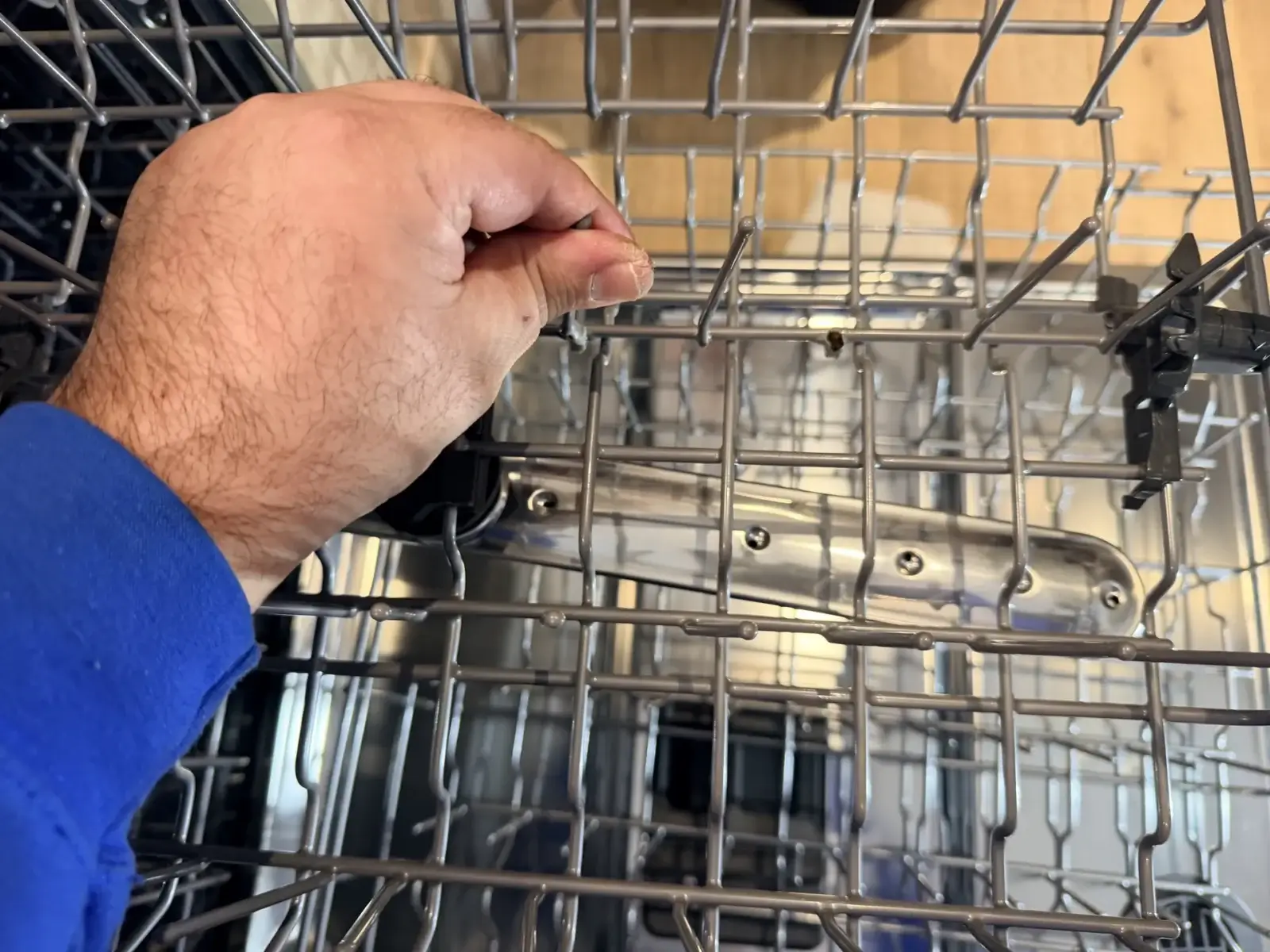 A technician adjusting the top rack of an open dishwasher during an independent appliance repair in Richmond Hill