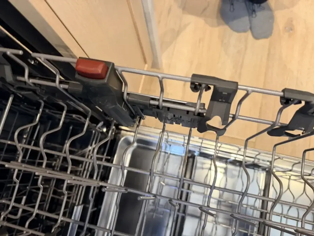 Dishwasher rack with the adjuster button, checked during a North York service call