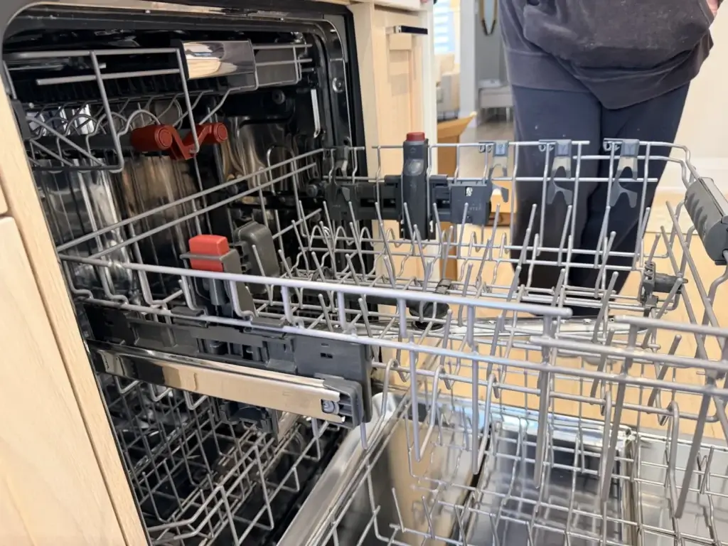dishwasher repair person stands next open dishwasher bradford ontario racks pull