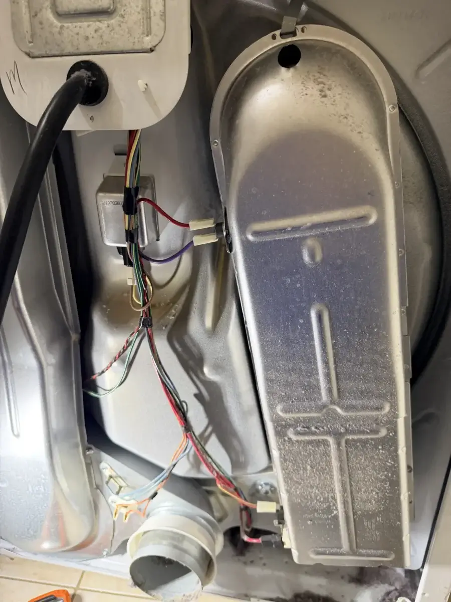 dryer repair image shows inside dryer exposing metal panels wires vents common s