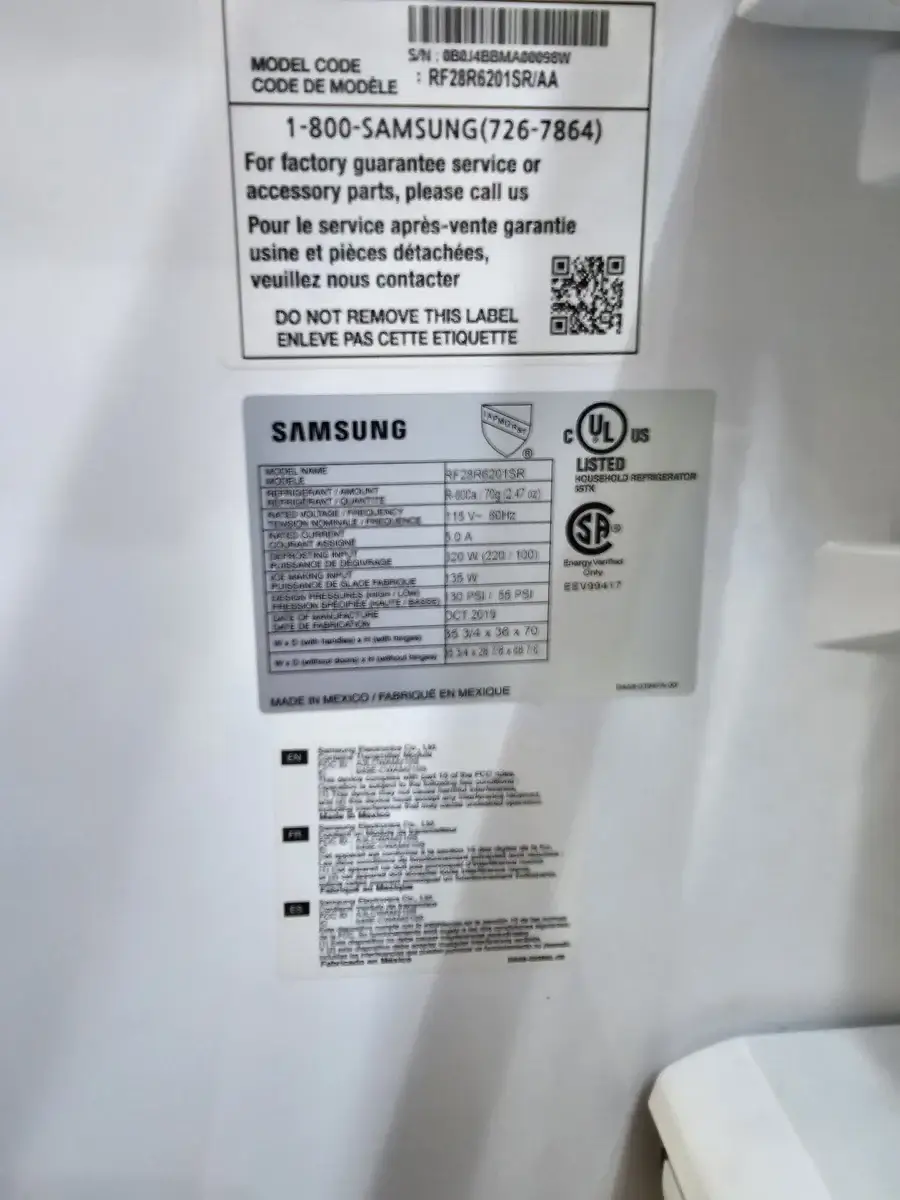 Close-up of appliance information and warranty labels reviewed during an independent appliance repair in the GTA