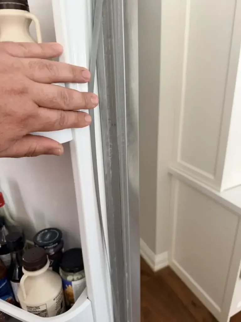 fridge repair hand touches gray rubber door seal open refrigerator bradford onta