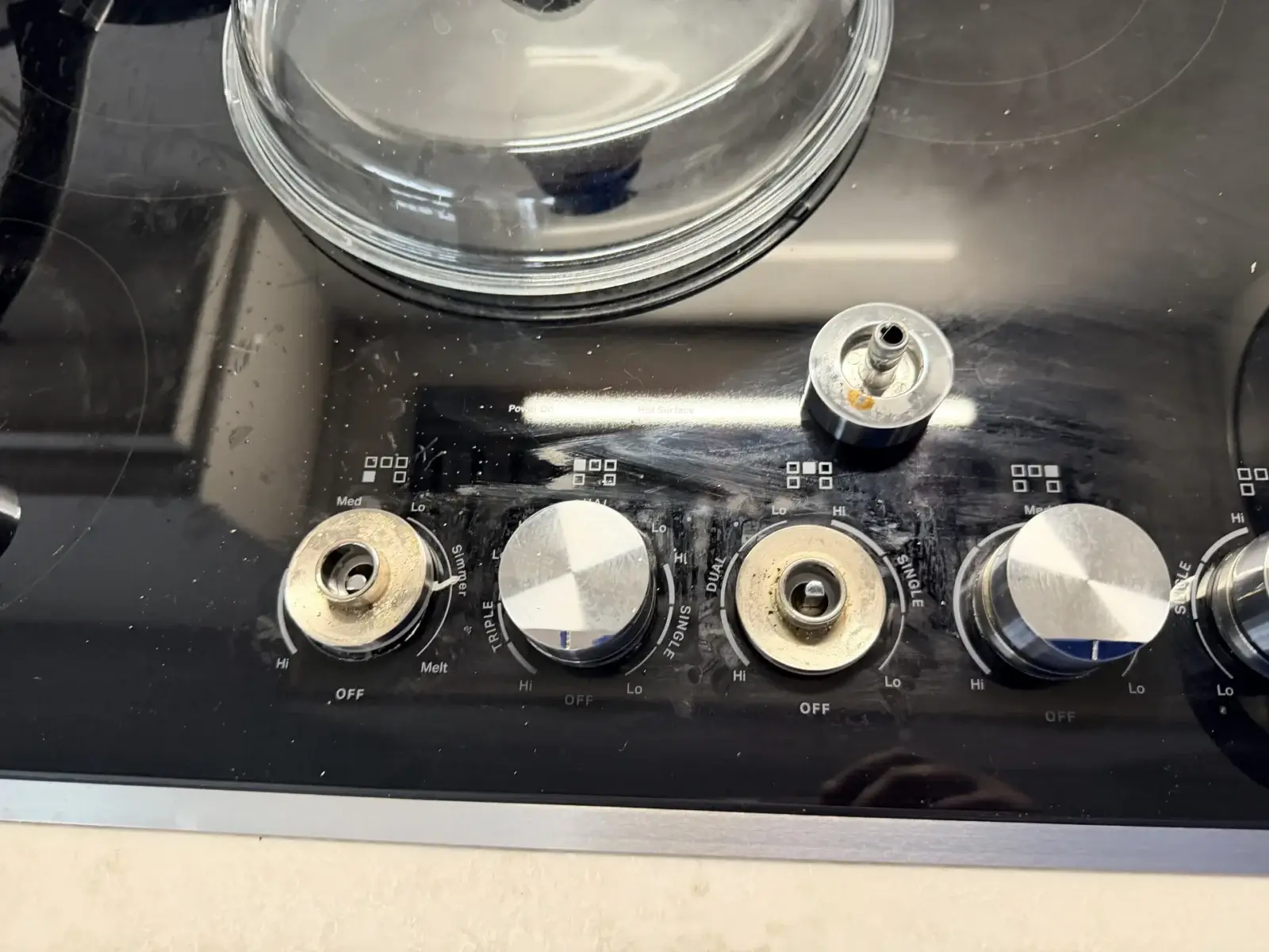 stove repair stovetop four metal control knobs one removed expose fitting beneat