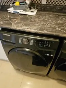 washer repair black samsung front load washing machine sits beneath dark marble