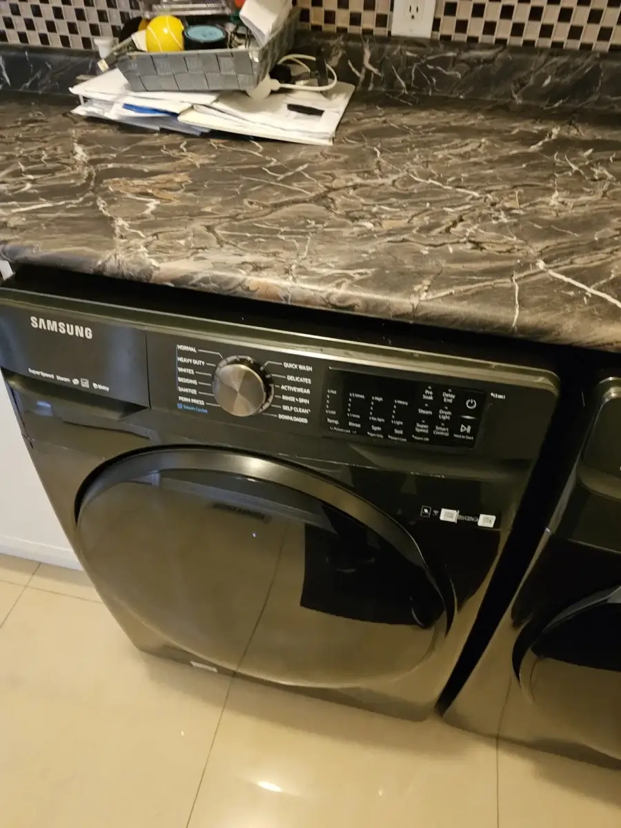 Black front-load washing machine in a GTA laundry room — the typical machine behind a washer repair cost question