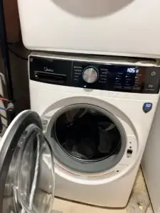 Front-load washer stopped mid-cycle with laundry in the drum