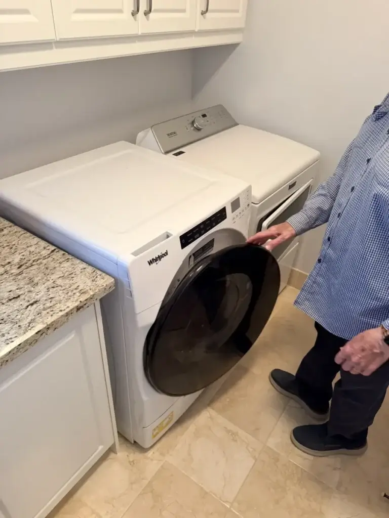 Front-load washer with the door open during the step-by-step drain check