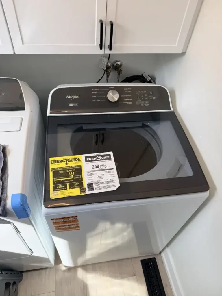 Whirlpool top-load washer with EnergyGuide labels ready for service