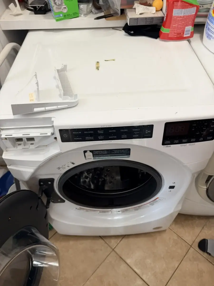 Front-load LG washer with the lower access panel area where the drain pump filter is located