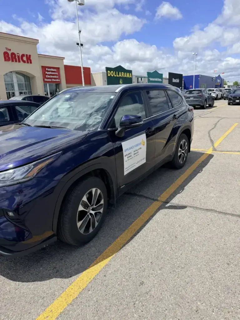 Appliance Forever blue Toyota Highlander parked on a local street outside a brick storefront in the Vaughan area
