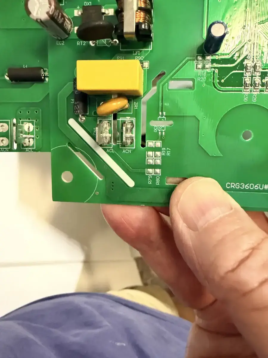 Appliance Forever technician holding a replacement appliance control board, the part that most often drives a repair quote