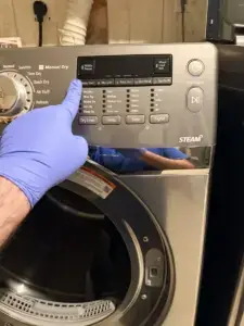 dryer repair technician nitrile glove inspecting control panel samsung steam fro