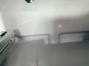 fridge repair close up back interior wall fridge showing condensation frost duri