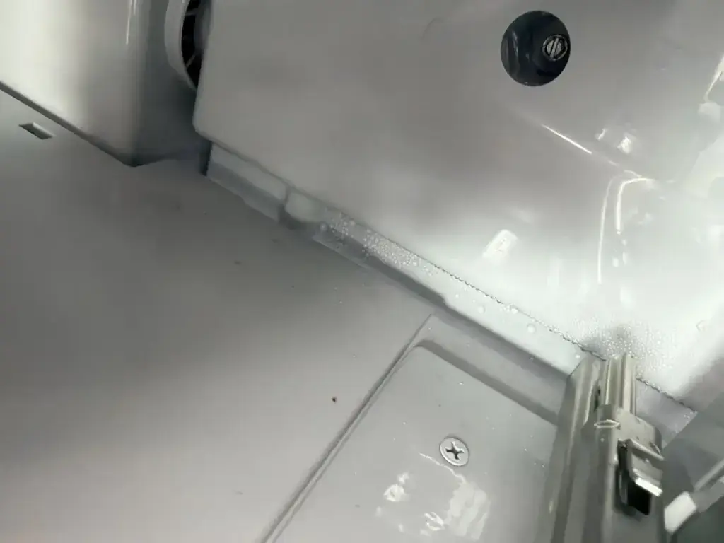 Condensation collecting inside the base of a refrigerator cabinet - one of the signs to weigh before a major repair
