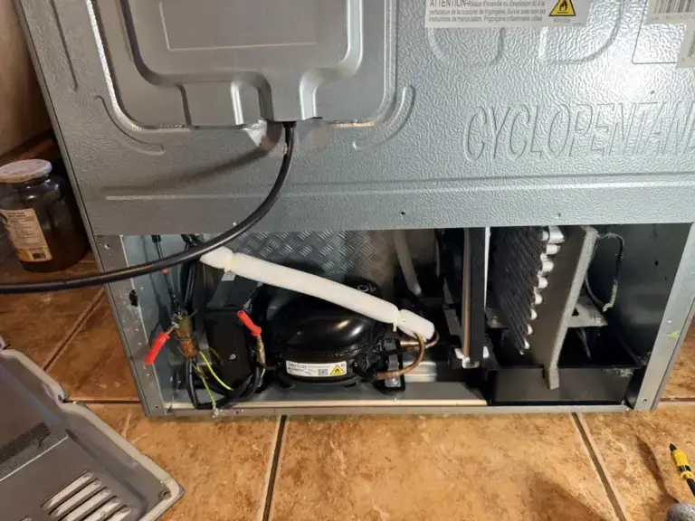 fridge repair rear refrigerator lower panel removed exposing compressor condense