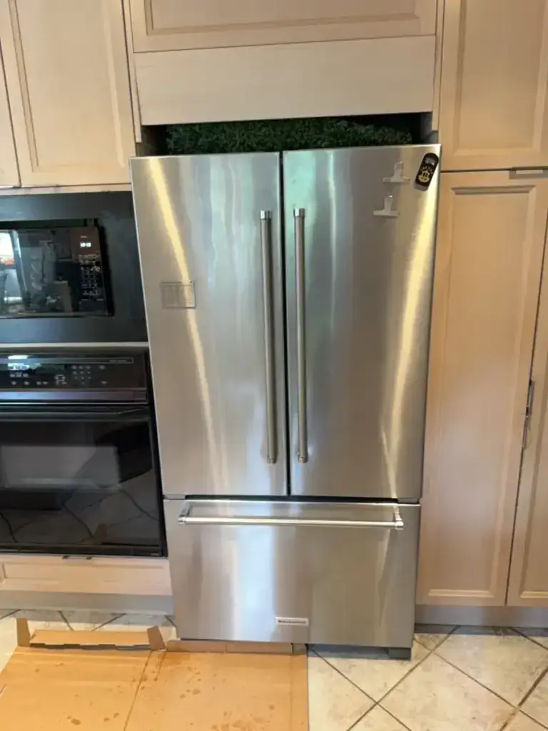 Stainless steel KitchenAid French-door refrigerator built into a kitchen - one of the fridge types we service in North York