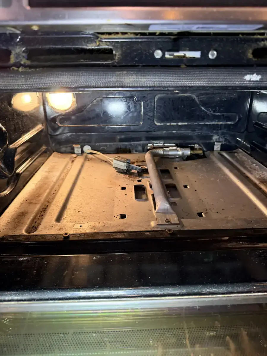 oven repair interior bottom soiled oven bake burner igniter exposed during repai