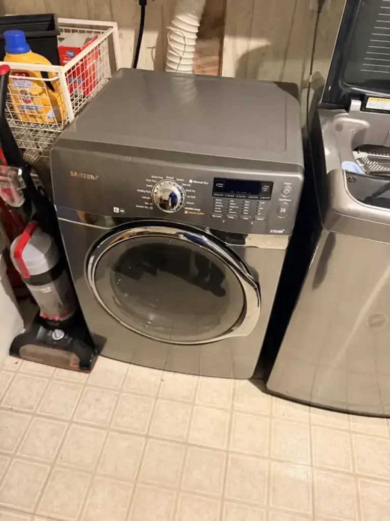 A gray Samsung steam front-load dryer beside a top-load washer in a GTA laundry room