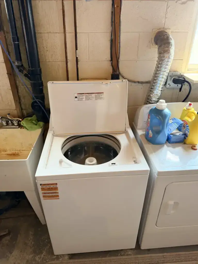 washer repair older white top load washer lid open beside dryer laundry detergen