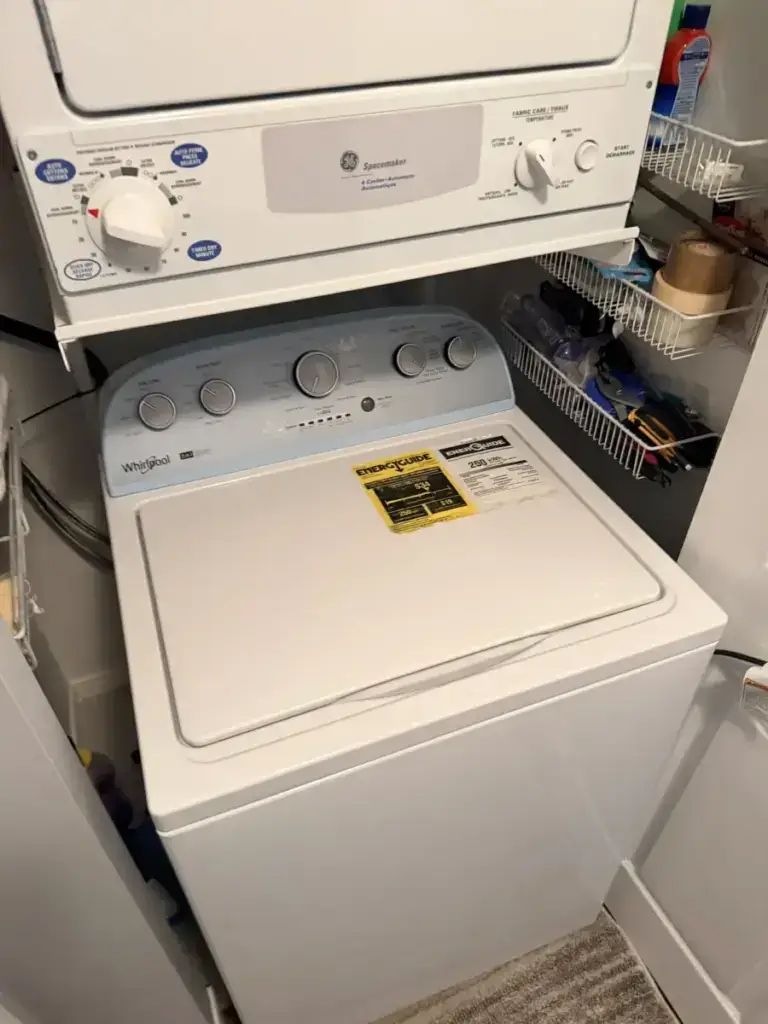 A stacked GE Spacemaker dryer over a white Whirlpool top-load washer in a GTA laundry area