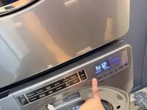 washer repair technician pointing digital control panel whirlpool front load was