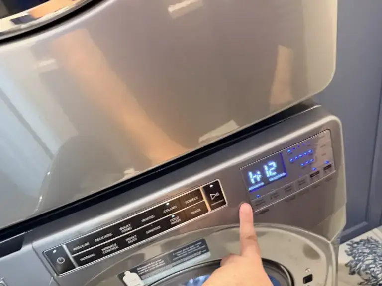 washer repair technician pointing digital control panel whirlpool front load was