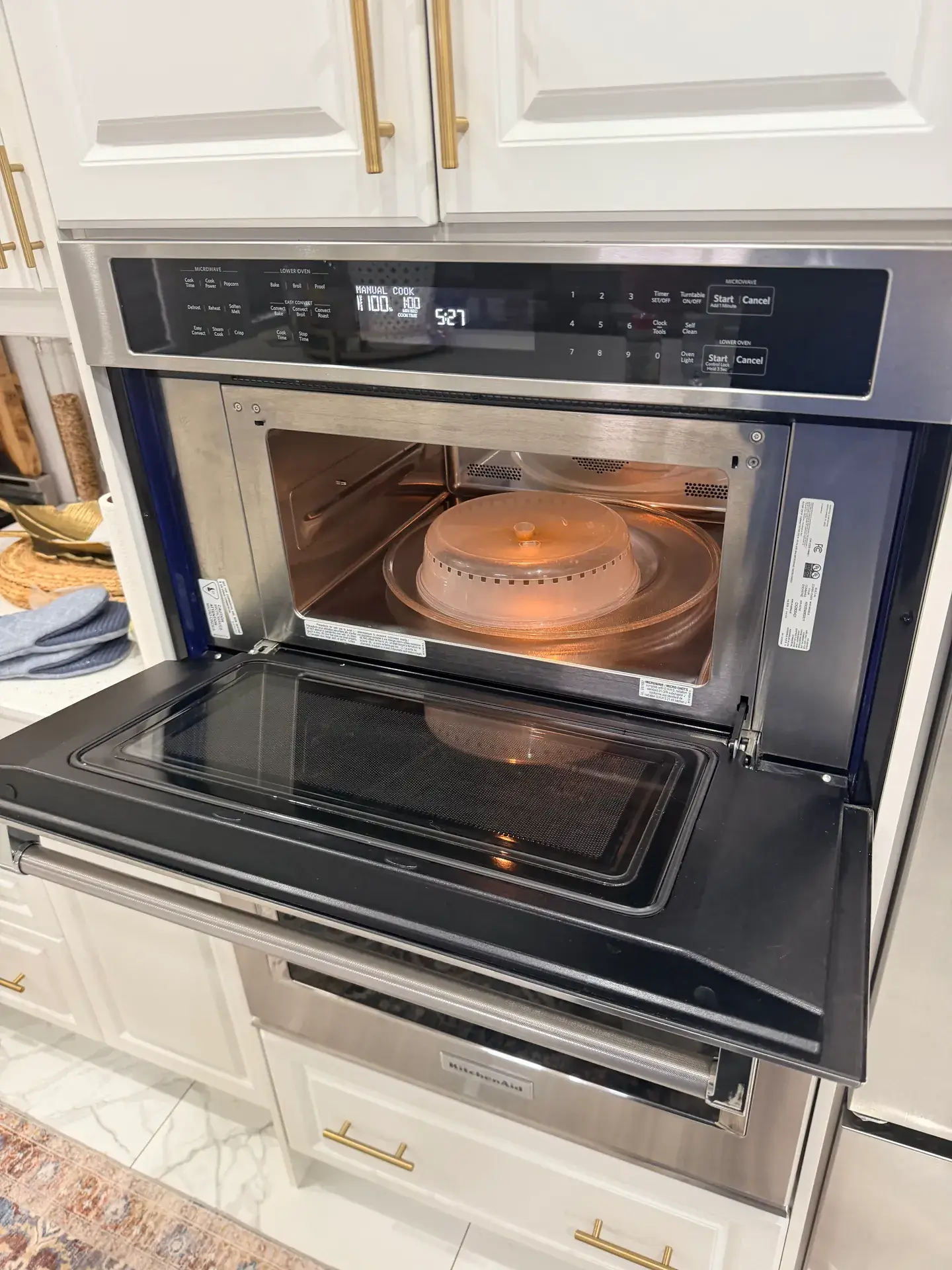 Built-in combination microwave and wall oven with the door open during a heating test on a service call in Bradford