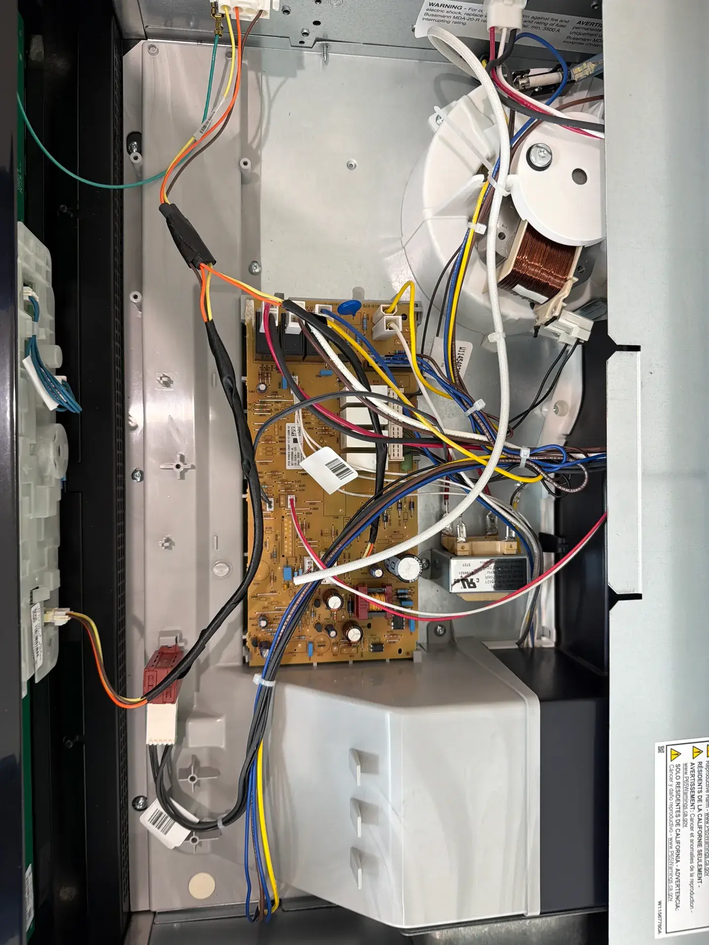 Microwave inner panel removed on a service call showing the control board, wiring harness and high-voltage transformer