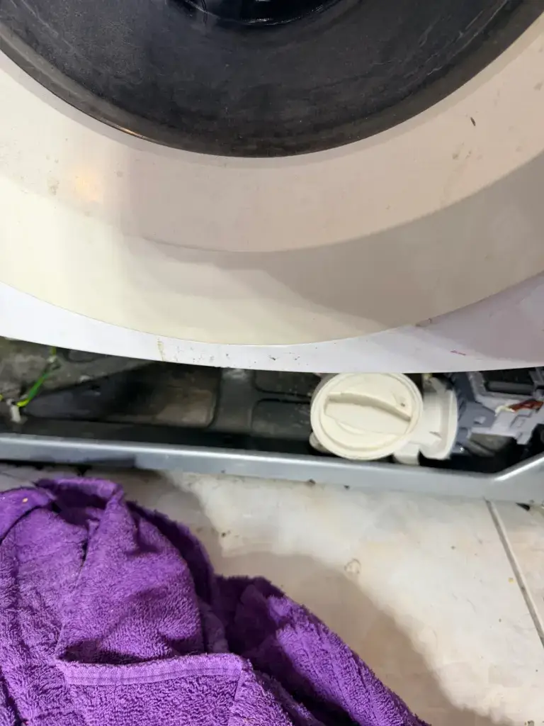 Washer drain pump and hose at the base of the outer tub - Appliance Forever appliance repair in Alliston, Ontario.